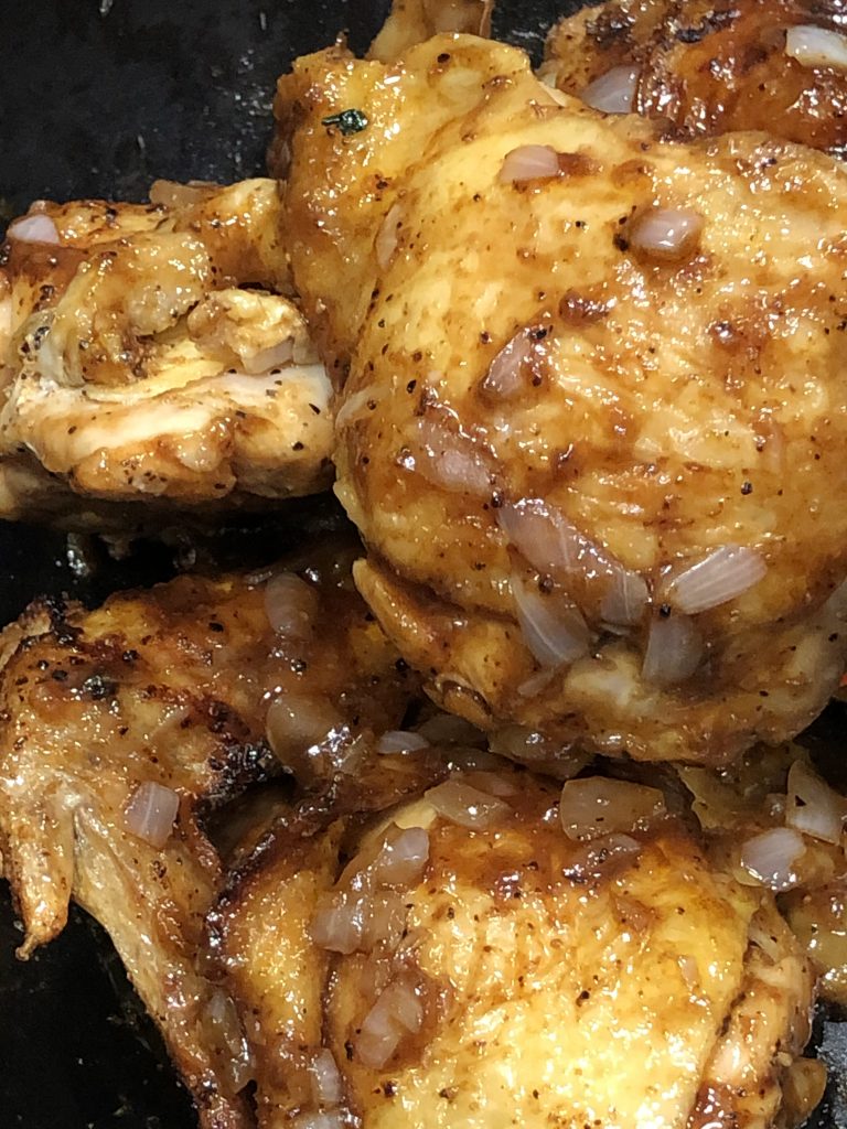 Baked Chicken Thigh covered with sauce and onion