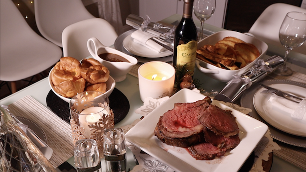 Roast beef, yorkshire pudding, gravy, caymus wine on the table ready for roast dinner 