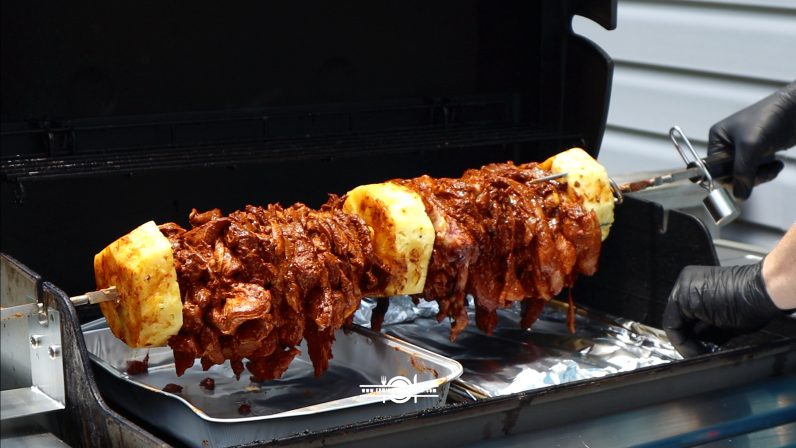 stacked of pineapple and marinated pork meat in a bbq ready for grilling