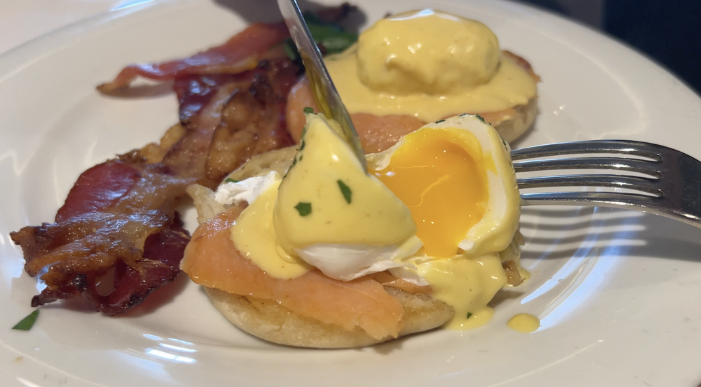 Eggs Benedict with smoked salmon and bacon on a plate