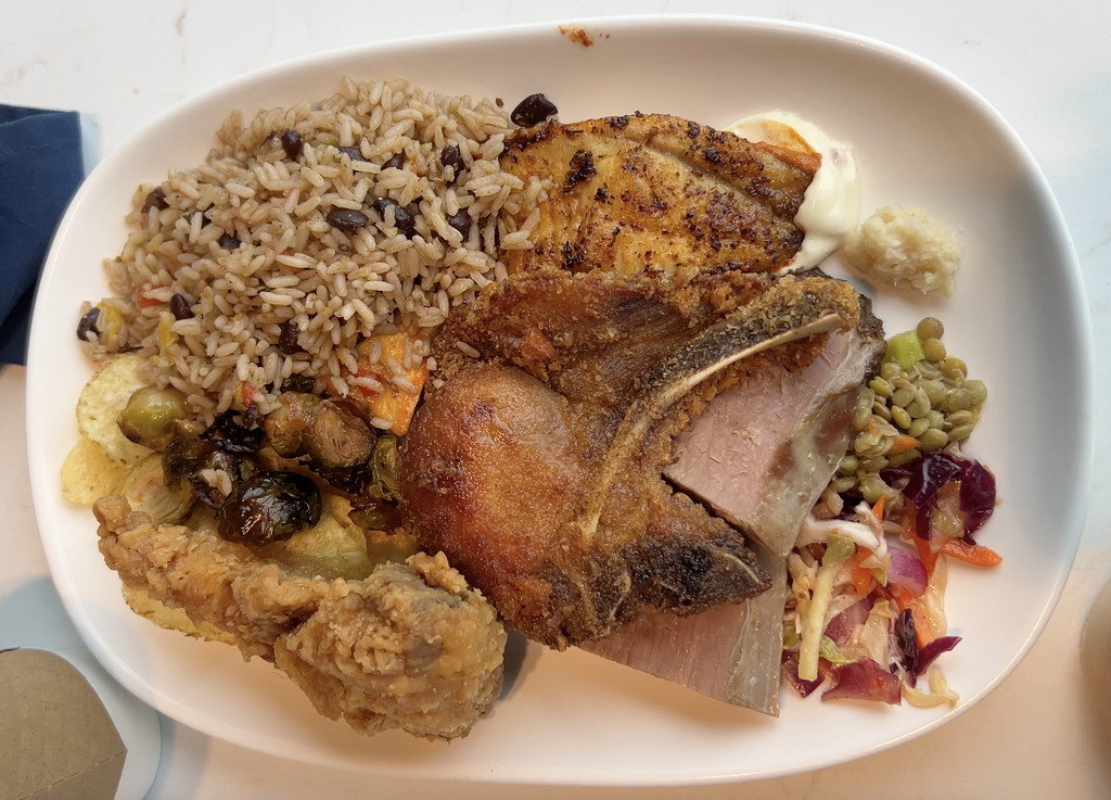 Plate with rice and beans, pork chop and sides from the ship buffet